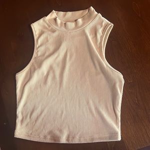 beige sleeveless top.